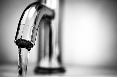 a close up of a tap with water running